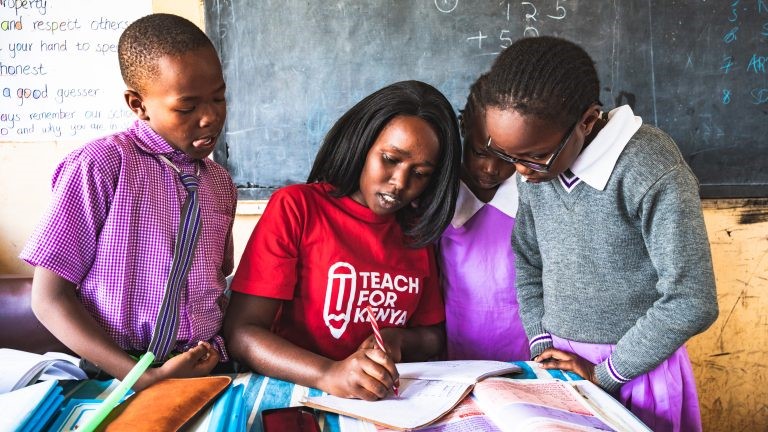  A young Kenyan Teacher with pupils - Photo Courtesy  - Online